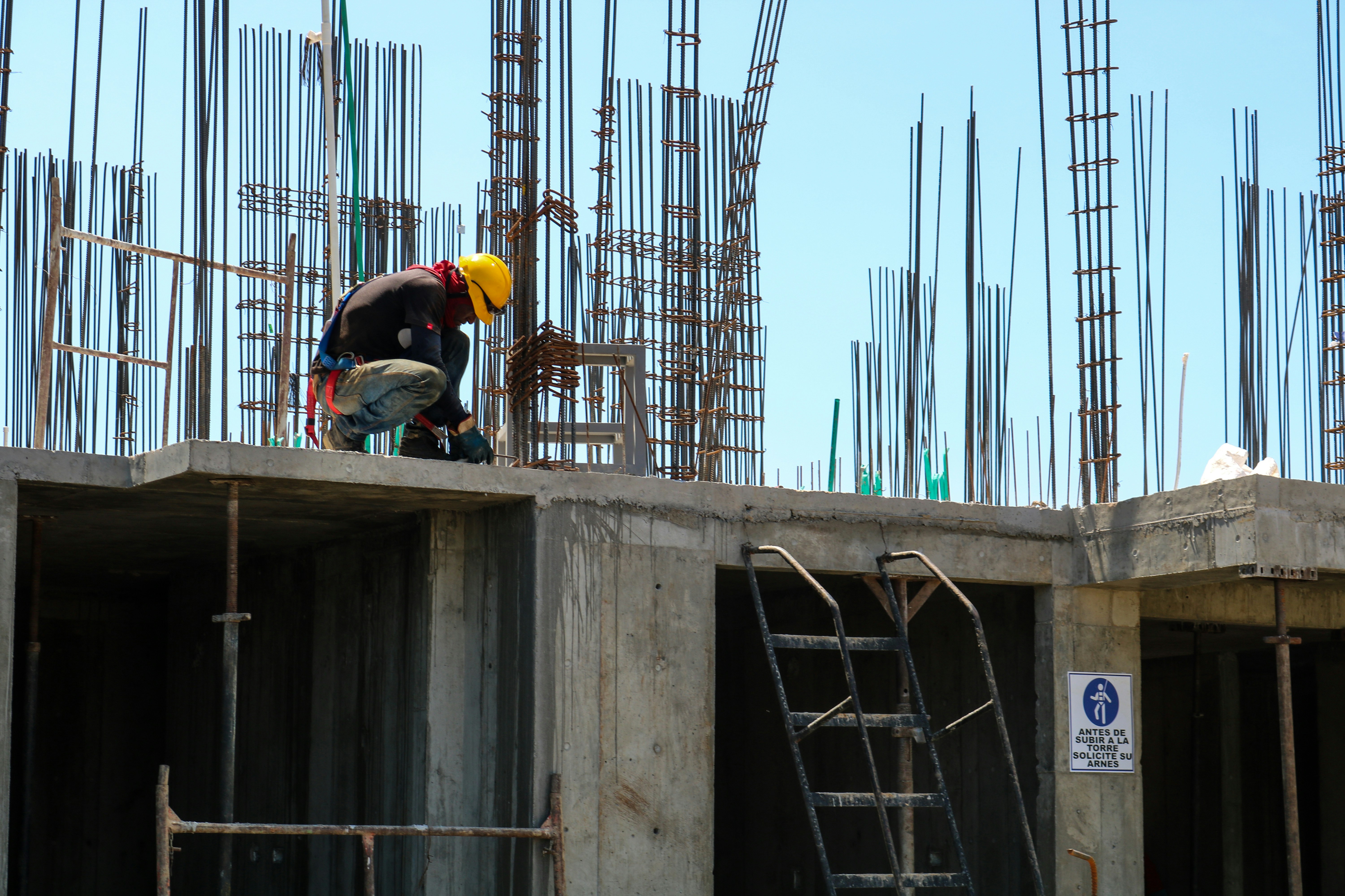 Workers on concrete framework highlighting teamwork and structural expertise